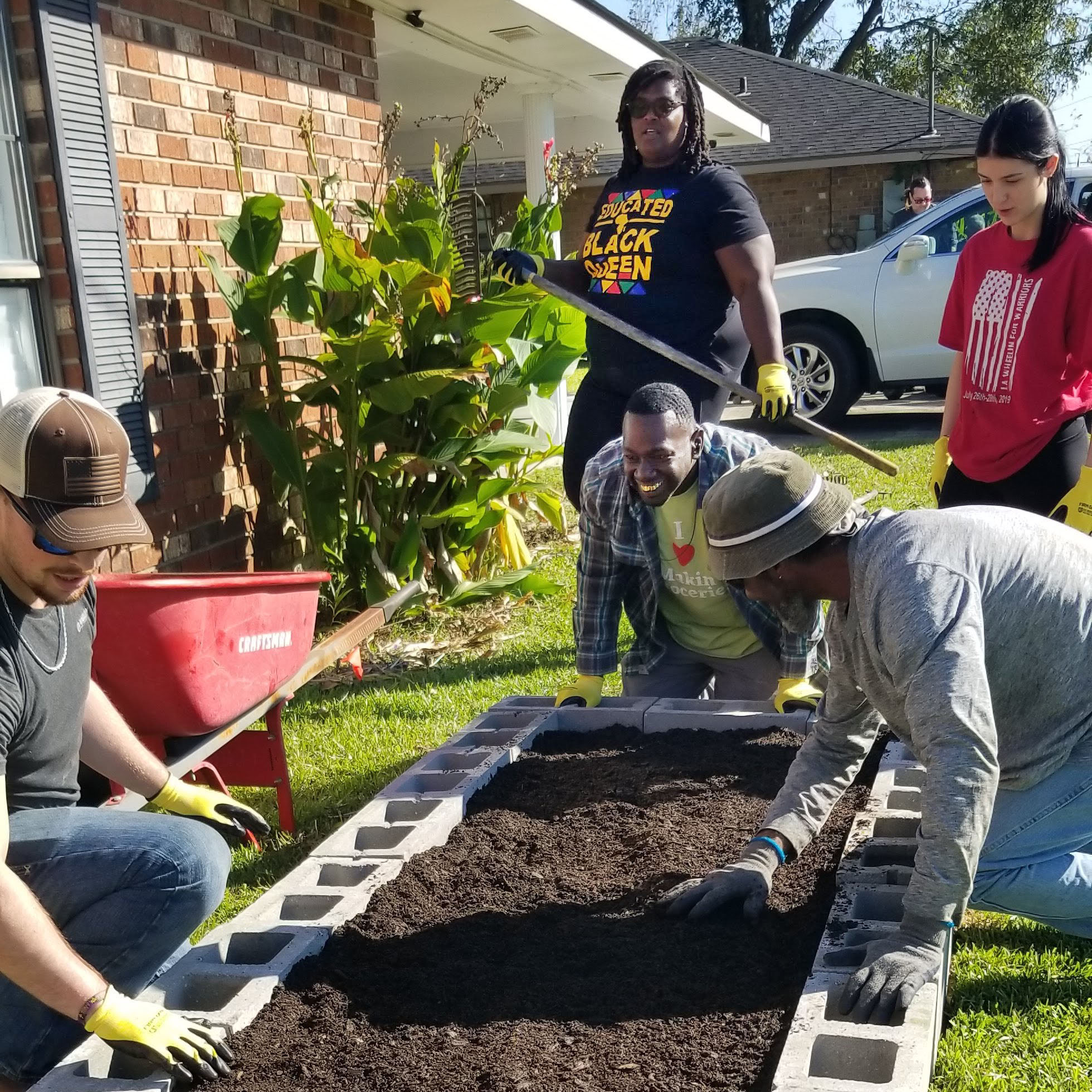 Nicole Ryane Johnson helps community members build raised garden beds