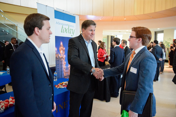 two men in suits shaking hands