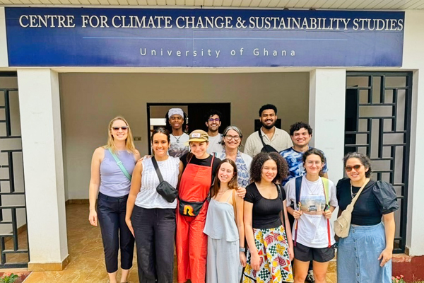 Group of students in front of a sign reading Centere for Climate Change & Sustainability Studies. 