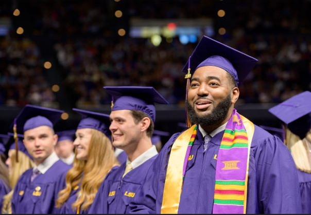 students wearing caps and gowns at graduation.