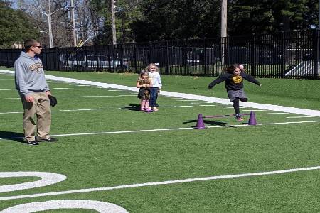 PE teacher coaching elementary school students