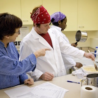 Student prepares dish in cooking class.