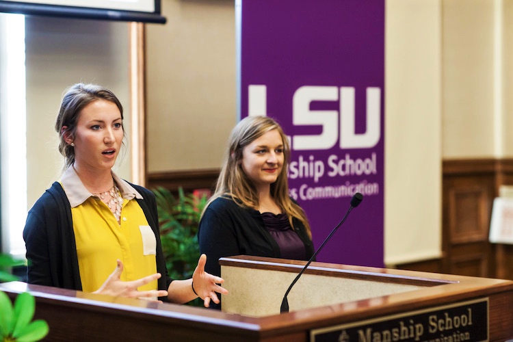 Public relations students speaking behind podium