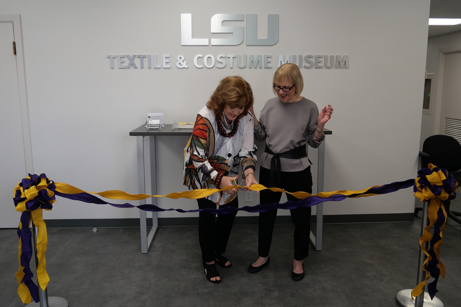 Jeanne cutting the ribbon